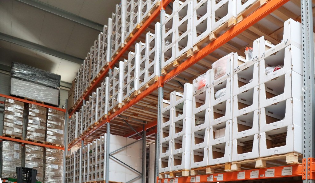 White Pickbox bins stacked on pallets in industrial racking